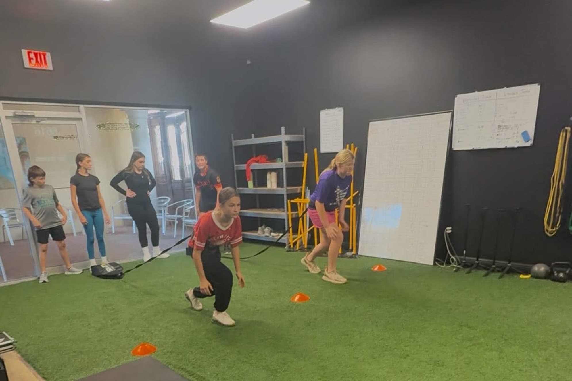 Young athletes taking turns on a banded lateral drill
